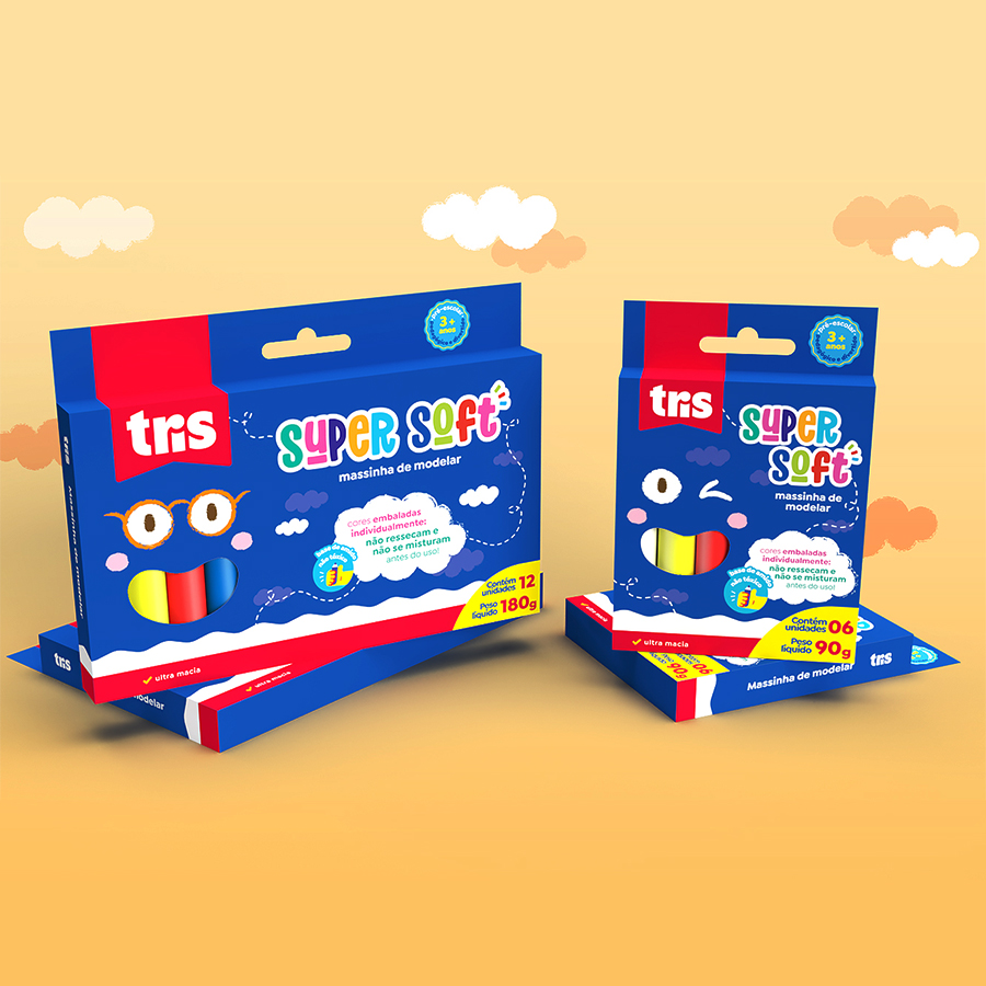 Two blue boxes of 'Tris Super Soft' modeling clay are shown against an orange and white background that resembles a sky with clouds.